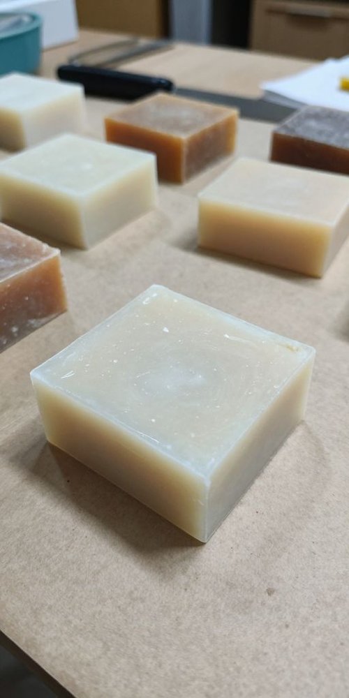 Before photo of handmade soap bars on a craft table